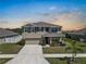 Charming two-story home featuring a well-manicured lawn and inviting curb appeal at 718 Tidal Rock Ave, Ruskin, FL 33570