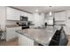 Bright kitchen boasts white cabinets, stainless appliances, and large island with barstool seating at 718 Tidal Rock Ave, Ruskin, FL 33570