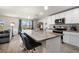 Open-concept kitchen with white cabinets, stainless steel appliances, and granite countertops at 718 Tidal Rock Ave, Ruskin, FL 33570