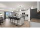 Modern kitchen featuring white cabinetry, stainless steel appliances, and a large center island with bar seating at 718 Tidal Rock Ave, Ruskin, FL 33570