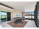 Relaxing screened lanai with seating area and dining table overlooking yard and pond at 718 Tidal Rock Ave, Ruskin, FL 33570