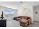 Comfortable living room with couch, large window providing a picturesque lake view at 718 Tidal Rock Ave, Ruskin, FL 33570