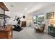 Bright living room with a large window and plush carpet flooring and exercise equipment at 718 Tidal Rock Ave, Ruskin, FL 33570