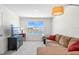 Inviting living room with sofa, television, and a large window overlooking the water at 718 Tidal Rock Ave, Ruskin, FL 33570