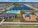 Aerial view of community recreational facilities featuring pool, clubhouse, and playground, promoting active lifestyles at 718 Tidal Rock Ave, Ruskin, FL 33570