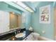 Bright bathroom with black granite countertops and tile shower at 7314 Hunt Club Ln, Seminole, FL 33776