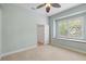 Cozy bedroom showcasing a built-in window seat, ceiling fan and closet access at 7314 Hunt Club Ln, Seminole, FL 33776