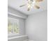 Neutral bedroom design includes large window, ceiling fan, and white trim at 7314 Hunt Club Ln, Seminole, FL 33776