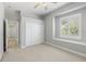Bright bedroom features a window with white trim, a closet, and neutral carpet at 7314 Hunt Club Ln, Seminole, FL 33776