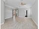 Spacious bedroom featuring wood-look flooring, tray ceilings and multiple access doors to adjacent spaces at 7314 Hunt Club Ln, Seminole, FL 33776