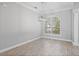 Bright dining room featuring modern light fixtures, plantation shutters, and neutral paint at 7314 Hunt Club Ln, Seminole, FL 33776