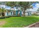 Charming home boasting an impeccably manicured lawn and complemented by lush green shrubbery at 7314 Hunt Club Ln, Seminole, FL 33776