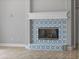 A close view of a fireplace surrounded with decorative, floral, patterned blue tile at 7314 Hunt Club Ln, Seminole, FL 33776