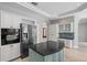Kitchen with a large stainless fridge, built-in oven, and serving island at 7314 Hunt Club Ln, Seminole, FL 33776