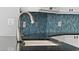 Close-up of a modern kitchen sink and countertop with stylish backsplash at 7314 Hunt Club Ln, Seminole, FL 33776
