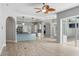 Spacious living room showcasing tile flooring, kitchen access and sliding glass doors to the patio at 7314 Hunt Club Ln, Seminole, FL 33776