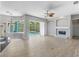 Open living room features tile flooring, fireplace, and sliding glass doors to the pool area at 7314 Hunt Club Ln, Seminole, FL 33776