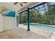 Relaxing enclosed pool area with television for entertainment at 7314 Hunt Club Ln, Seminole, FL 33776