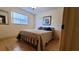 Cozy bedroom with hardwood floors, natural light, and a comfortable queen-sized bed at 7336 20Th N St, St Petersburg, FL 33702
