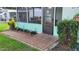 Exterior view of enclosed back porch from brick pathway at 7336 20Th N St, St Petersburg, FL 33702