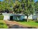 Beautifully landscaped home with a large front yard and a driveway leading to a garage at 7336 20Th N St, St Petersburg, FL 33702