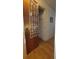 Hallway with wood flooring, closet, and organizer hanging on door at 7336 20Th N St, St Petersburg, FL 33702