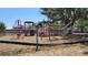 Community playground with a variety of play equipment and surrounding chain link fence at 7336 20Th N St, St Petersburg, FL 33702