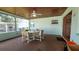 Enclosed sunroom with overhead fan and backyard views at 7336 20Th N St, St Petersburg, FL 33702