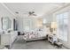 Inviting bedroom with a ceiling fan, floral bedding, dresser, and an abundance of natural light from multiple windows at 757 32Nd N Ave, St Petersburg, FL 33704