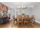 Elegant dining area with hardwood floors, a wood-burning stove, and a view of the staircase at 757 32Nd N Ave, St Petersburg, FL 33704