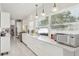 Modern kitchen featuring sleek white cabinets, granite countertops, tile floors, and stainless steel appliances at 757 32Nd N Ave, St Petersburg, FL 33704