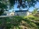 Backyard featuring green grass, a partial view of the home, and chain link fencing at 7615 Lavender Ln, Tampa, FL 33619