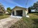 A detached one-car garage with an open door and gray concrete driveway at 8326 Lafitte Dr, Hudson, FL 34667