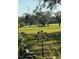 Picturesque view of golf course from back yard, with mature shade trees and an open green at 836 Magellan Dr, Sarasota, FL 34243