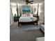 Inviting bedroom featuring a four-poster bed, soft carpet, and natural light, creating a serene and relaxing atmosphere at 836 Magellan Dr, Sarasota, FL 34243
