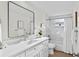 Modern bathroom with marble-tiled shower over tub, with updated vanity and fixtures at 9218 Glen Moor Ln, Port Richey, FL 34668