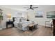 Bedroom with wood-look flooring, two windows and a ceiling fan at 9218 Glen Moor Ln, Port Richey, FL 34668