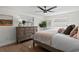 Bright bedroom with wood-look flooring, a ceiling fan, and two windows at 9218 Glen Moor Ln, Port Richey, FL 34668