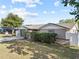 Attractive home with a well-kept lawn, mature trees, and a welcoming entrance, offering a comfortable living environment at 9218 Glen Moor Ln, Port Richey, FL 34668