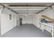 Clean and organized garage with plenty of storage space, workbench, and access to the home at 9218 Glen Moor Ln, Port Richey, FL 34668