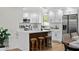 Modern kitchen with white cabinetry, stainless steel appliances, and a convenient island at 9218 Glen Moor Ln, Port Richey, FL 34668