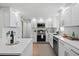Updated kitchen featuring white cabinets, quartz countertops, and stainless steel appliances at 9218 Glen Moor Ln, Port Richey, FL 34668
