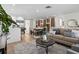 Cozy living area showcasing stylish decor, hardwood floors, and seamless flow to the dining space at 9218 Glen Moor Ln, Port Richey, FL 34668