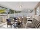 Relaxing sun room with comfortable seating and dining area, perfect for enjoying the outdoors inside at 9218 Glen Moor Ln, Port Richey, FL 34668