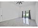 Bright living room featuring tile floors, gray curtains, and backyard access at 10104 N Dartmouth Ave, Tampa, FL 33612