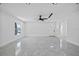 Bright living room featuring tile floors, a ceiling fan, and a front door at 10104 N Dartmouth Ave, Tampa, FL 33612