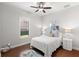 Comfortable bedroom with fan, hard wood floors, shutters and calming decor at 1013 Stella Vara Dr, Lutz, FL 33548