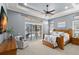 Beautiful main bedroom suite with ceiling fan, sitting area, slider, and plush carpet at 1013 Stella Vara Dr, Lutz, FL 33548