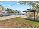 Spacious backyard featuring a pool, gazebo, privacy fence, and palm trees at 1025 Boca Ciega Isle Dr, St Pete Beach, FL 33706