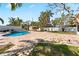 Spacious backyard featuring a pool, gazebo, privacy fence, and palm trees at 1025 Boca Ciega Isle Dr, St Pete Beach, FL 33706